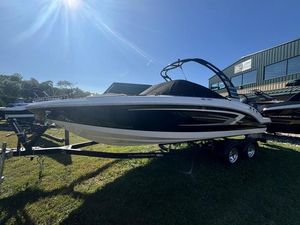Chaparral 23 SSi OB 2024 Chaparral 23 SSi OB boat on trailer, sunny day, grassy area.