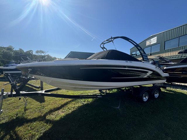 Chaparral 23 SSi OB 2024 Chaparral 23 SSi OB boat on trailer, sunny day, grassy area.