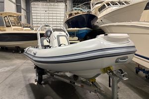 Highfield Classic 400 2025 Highfield Classic 400 inflatable boat in storage, surrounded by larger vessels.