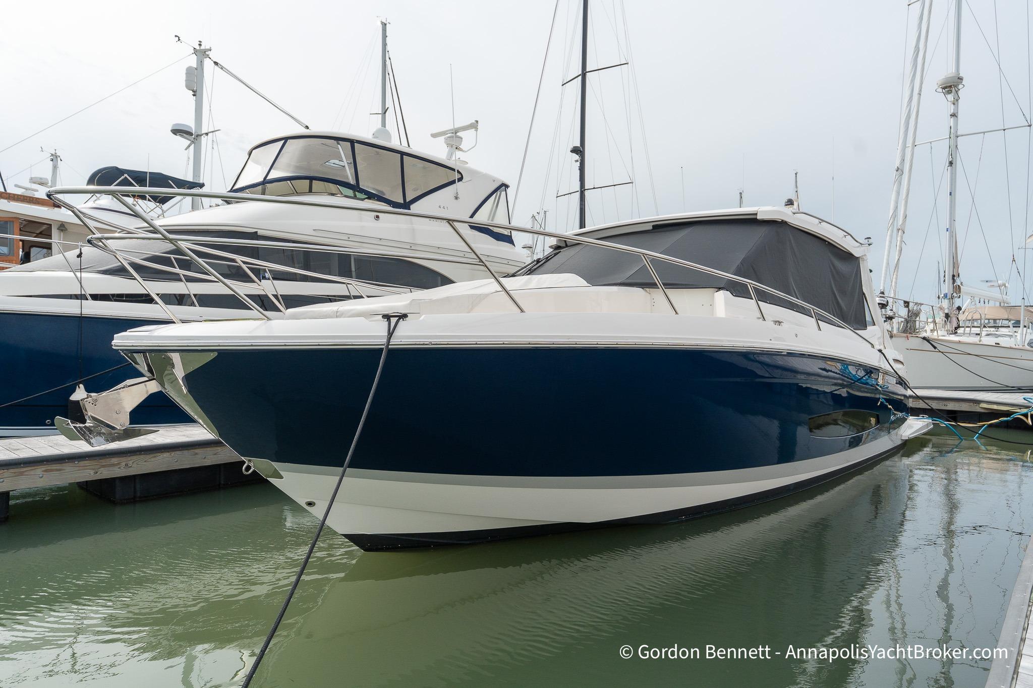 Regal 36 XO 2024 Regal 36 XO yacht docked in marina, showcasing sleek design and modern features.