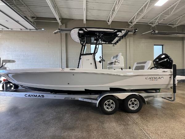 Caymas 26 HB 2024 Caymas 26 Hybrid boat on trailer in indoor showroom.