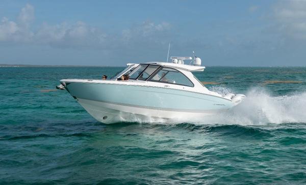 Regal LX36 2022 Regal LX36 boat cruising on clear turquoise waters.