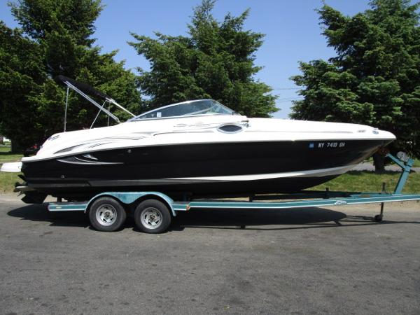 Sea Ray 240 Sundeck 2005 Sea Ray 240 Sundeck boat on a trailer, side view.