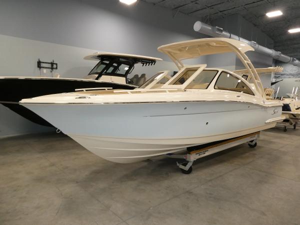 Scout 240 Dorado 2024 Scout 240 Dorado boat displayed in a showroom.