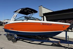Cobalt R6 2022 Cobalt R6 boat in orange and blue on a trailer, parked outdoors.