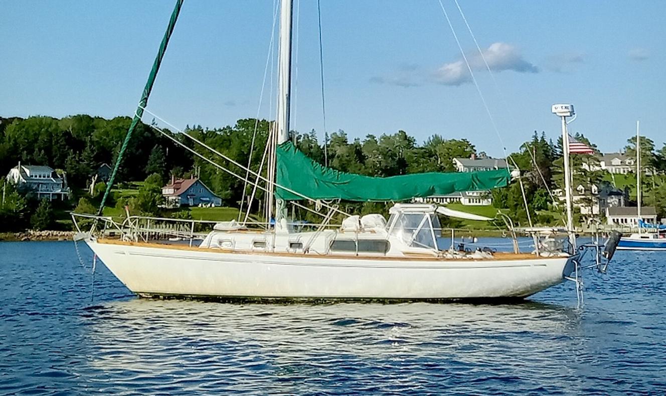 Morgan 34 - Centerboard 1966 Morgan 34 Centerboard sailboat anchored in scenic coastal waters.