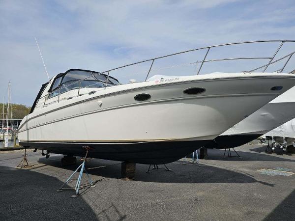 Sea Ray 370 Sundancer 1998 Sea Ray 370 Sundancer yacht on stands, displayed outdoors under a clear sky.