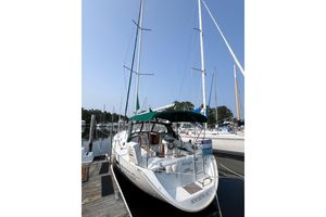 Beneteau 361 2002 Beneteau 361 sailboat docked, featuring green canopy and "For Sale" sign.