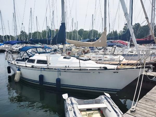 C&C 32 Sloop 1980 C&C 32 Sloop sailboat docked in a marina with other boats.