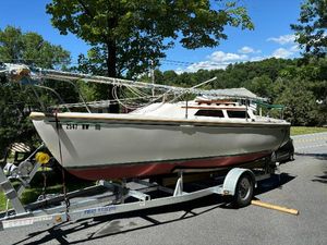 Catalina 22 Pop Top 1987 Catalina 22 Swing Keel sailboat on trailer, parked on a sunny road.