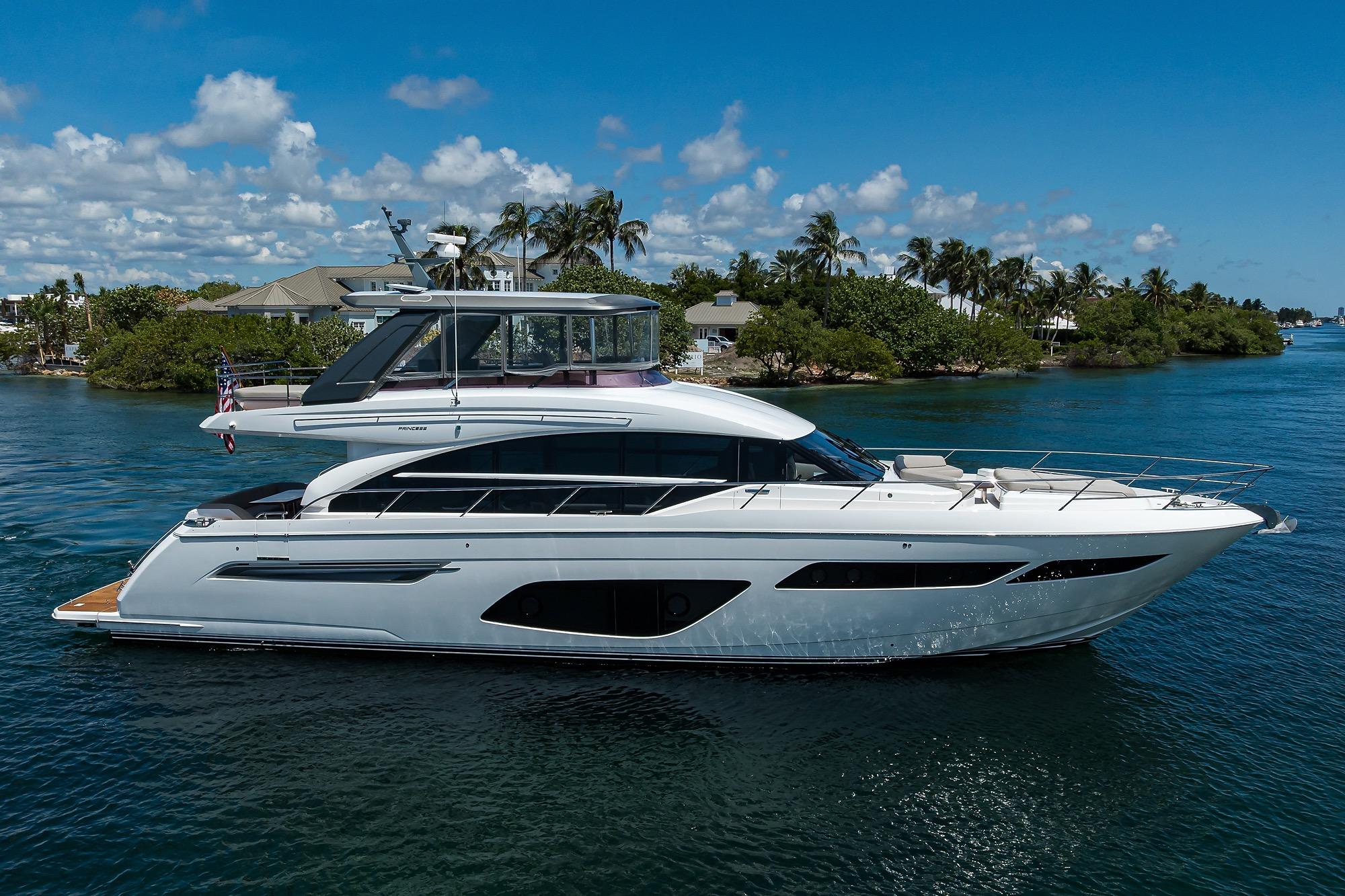 Princess F70 Luxurious 2020 Princess F70 yacht cruising on a sunny day, surrounded by tropical scenery.