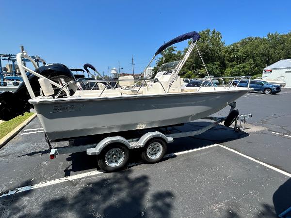 Boston Whaler 190 Montauk 2025 Boston Whaler 190 Montauk boat on a trailer in a parking lot.