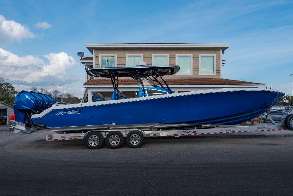 Nor-Tech 390 Center Console 2024 Nor-Tech 390 Center Console boat on a trailer, blue hull, triple engines.