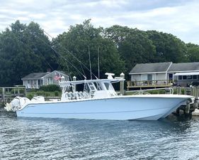 Invincible 46 Catamaran Plus Quad Axle Trailer 2023 Invincible 46 Catamaran docked, featuring quad axle trailer, surrounded by waterfront homes.