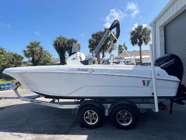 Wellcraft 202 Fisherman 2022 Wellcraft 202 Fisherman boat on trailer, parked outdoors near palm trees.