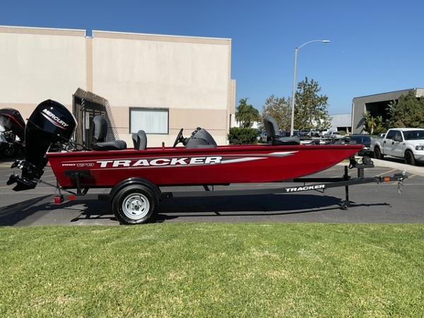 Tracker Pro 170 2025 Tracker Pro 170 boat on trailer, parked outdoors on sunny day.
