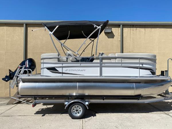 Starcraft LX 18 R 2023 Starcraft LX 18 R pontoon boat with canopy and outboard motor.