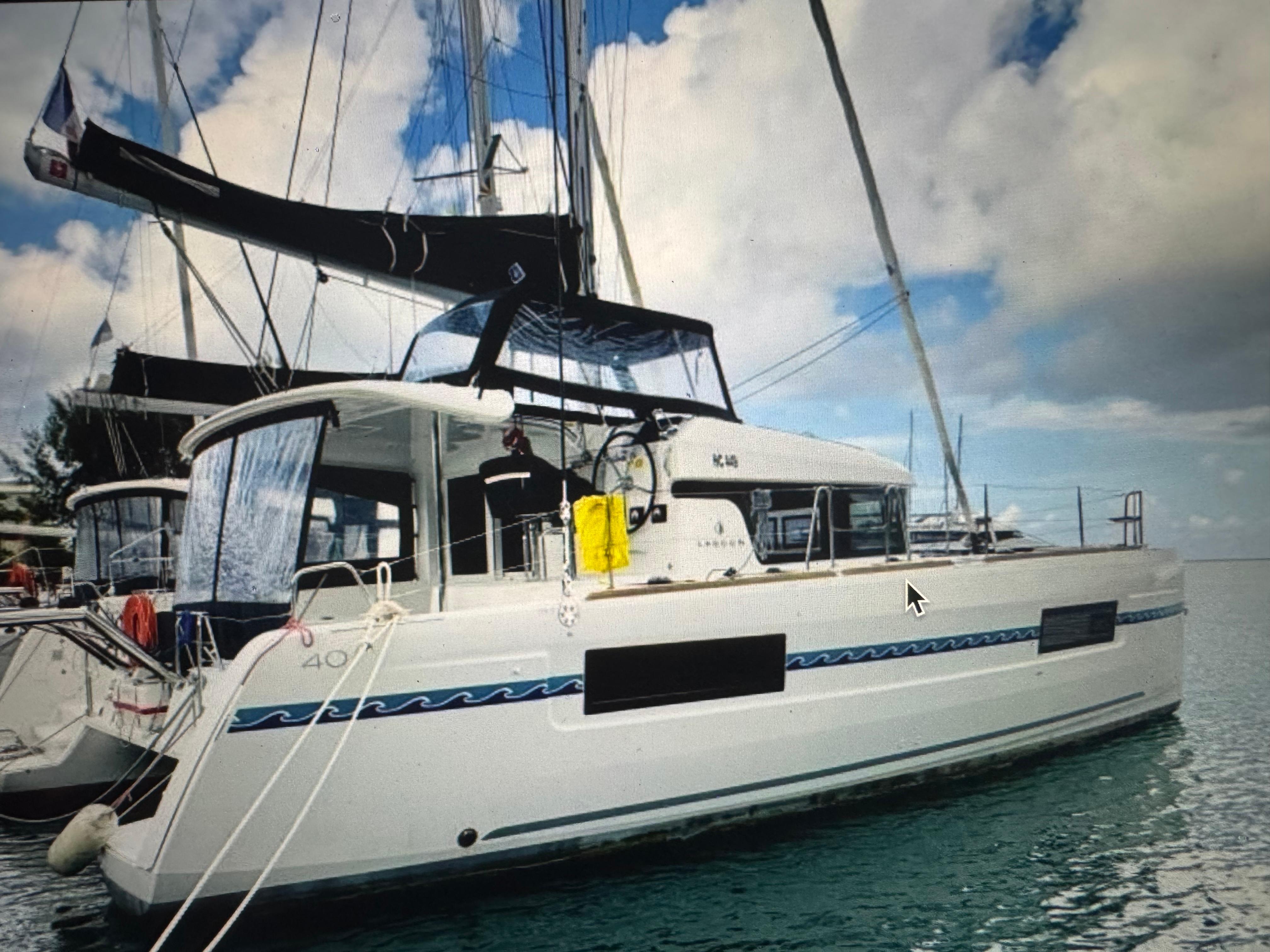 Lagoon 40 2018 Lagoon 40 catamaran docked, featuring sleek design and spacious deck.