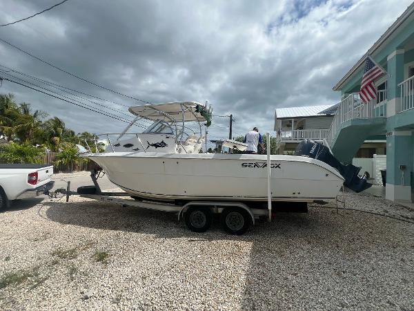 Sea Fox 257 Walk Around 2006 Sea Fox 257 Walk Around boat on trailer, parked in a residential driveway.