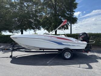 Tahoe T18 2023 Tahoe T18 boat on trailer, parked outdoors under trees.