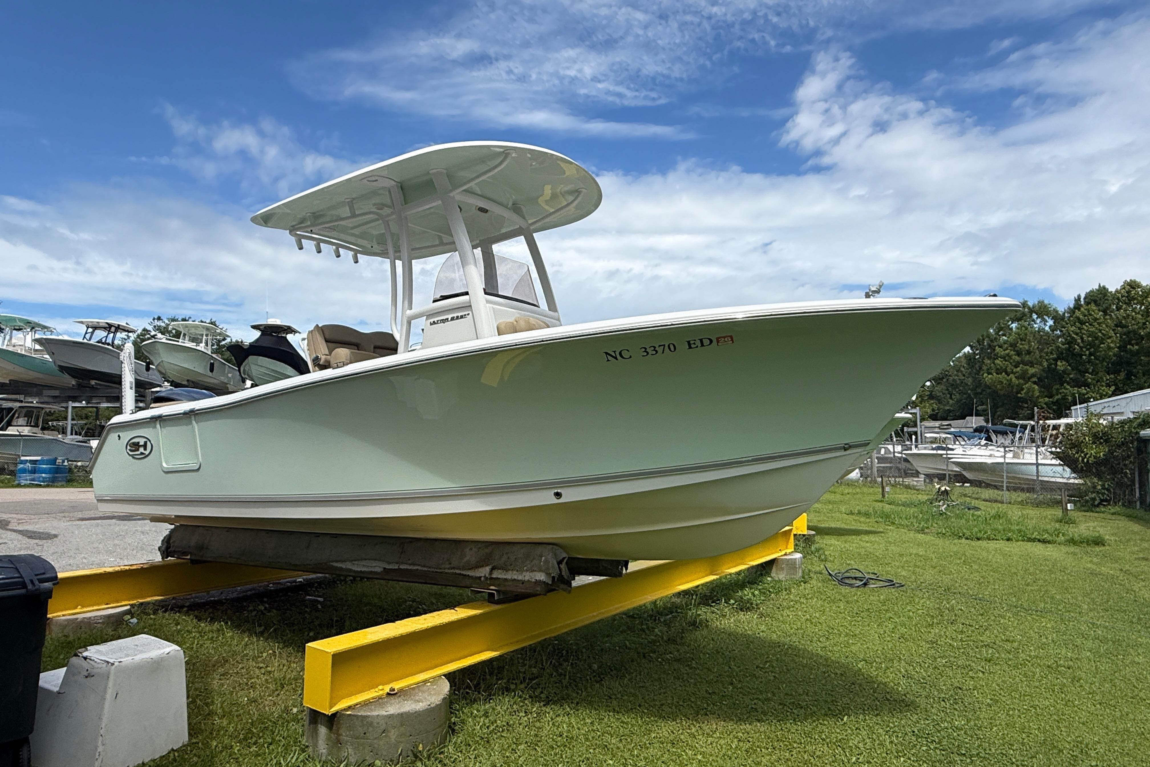 Sea Hunt Ultra 235 SE 2016 Sea Hunt Ultra 235 SE boat on display under a clear blue sky.