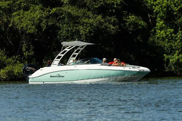 NauticStar 243 DC Manufacturer Provided Image: 2022 NauticStar 243 DC boat cruising on a lake with passengers.