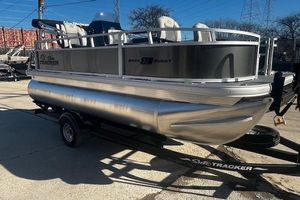 Sun Tracker Bass Buggy 16 XL Select 2026 Sun Tracker Bass Buggy 16 XL Select pontoon boat on trailer in outdoor setting.