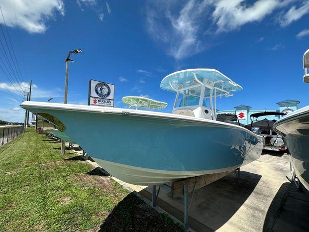 Sea Pro 239 Sport 2024 Sea Pro 239 Sport boat on display under a clear blue sky.