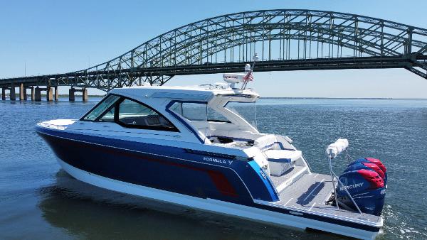 Formula 380 Super Sport Crossover OB 2022 Formula 380 Super Sport Crossover OB boat near a bridge on a sunny day.