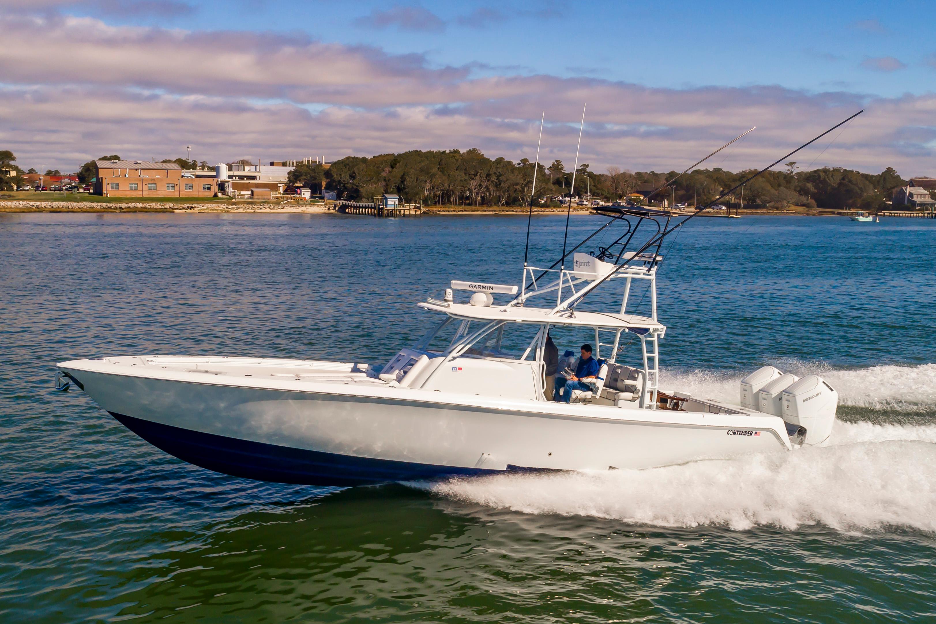 Contender 44FA 44ST 44 ST 2023 Contender 44FA boat cruising on a sunny day near the shoreline.