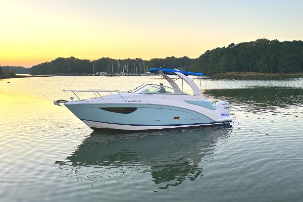 Regal 26XO 2022 Regal 26XO boat on calm water at sunset.