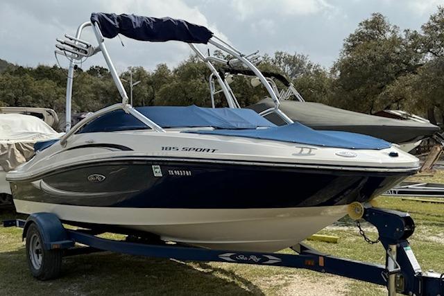 Sea Ray 185 Sport 2010 Sea Ray 185 Sport boat on trailer, parked outdoors.