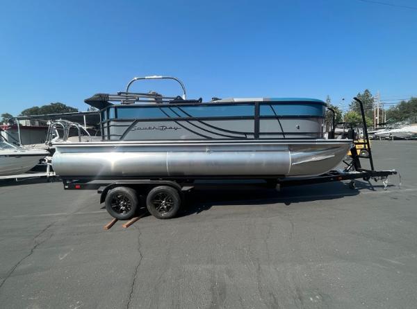 South Bay 220 CR 2024 South Bay 220 CR pontoon boat on a trailer in a parking lot.
