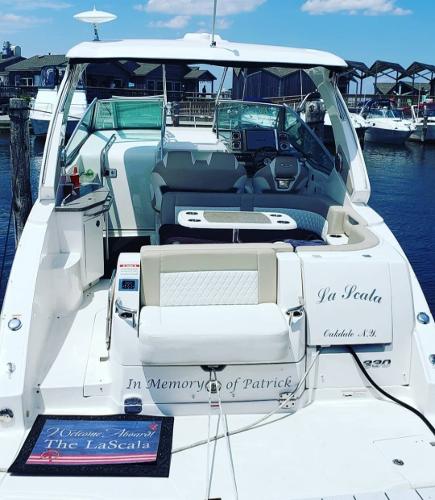 Chaparral 330 Signature 2014 Chaparral 330 Signature Cruiser docked, featuring spacious seating and modern controls.