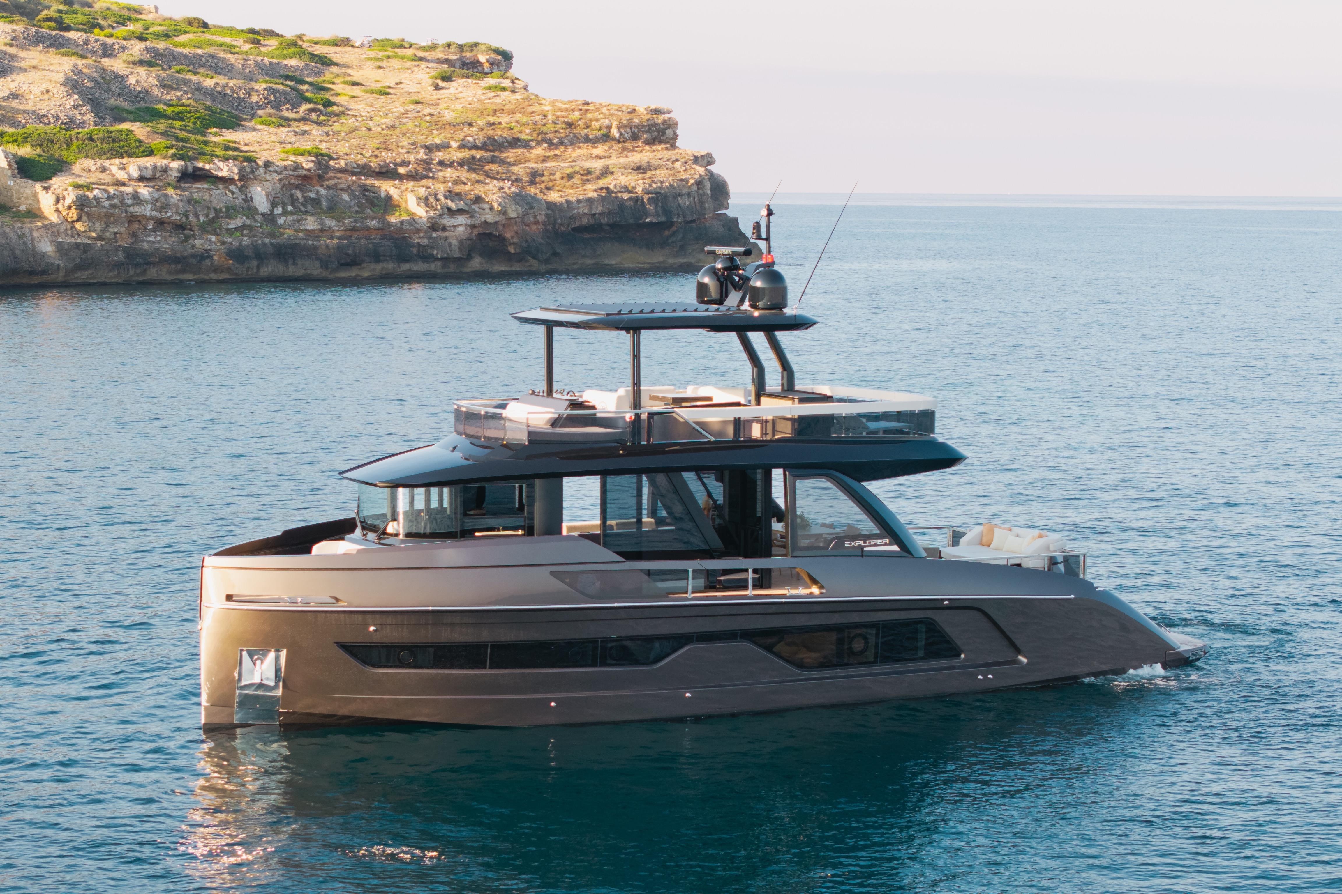 Explorer 62 Luxurious 2025 Explorer 62 yacht cruising near rocky coastline.