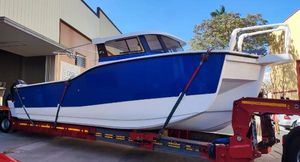 Olbap TR12 Blue Olbap TR12 boat on trailer, 2025 model, parked outside a building.