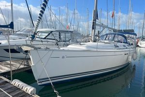 Dufour 385 2006 Dufour 385 sailboat docked in marina, surrounded by other boats.