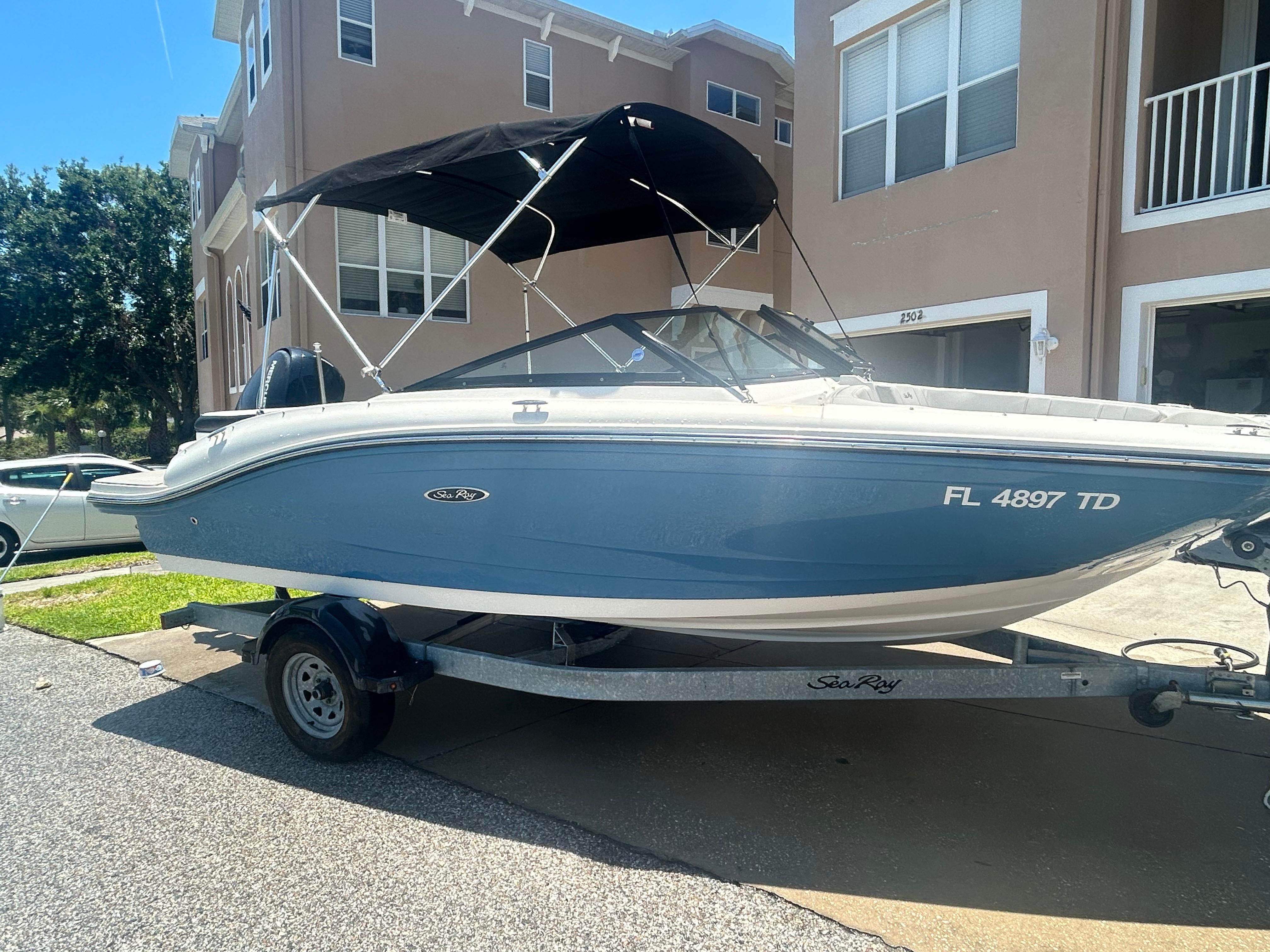 Sea Ray SPX 190 Outboard 2022 Sea Ray SPX 190 Outboard boat on trailer, parked in residential area.