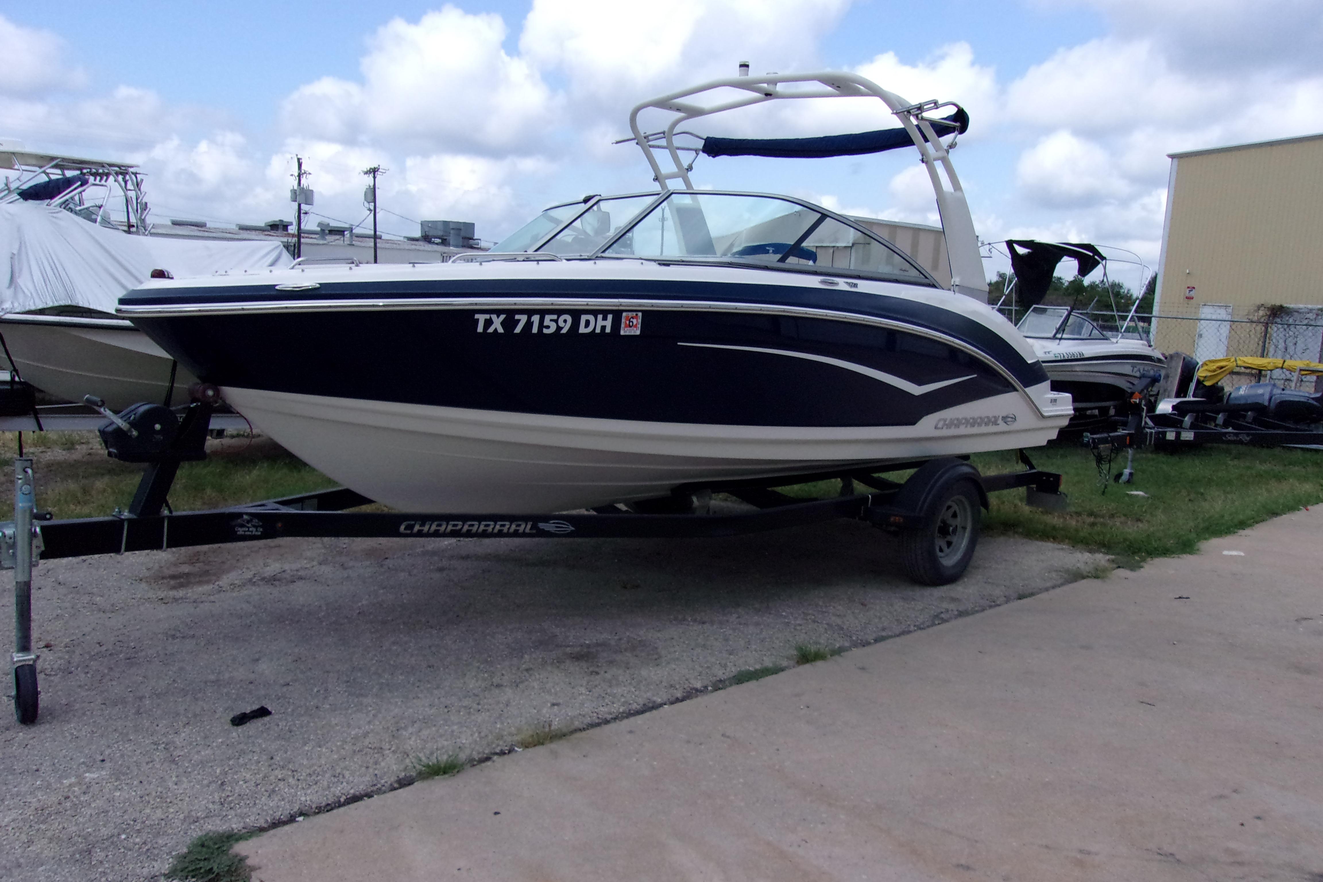 Chaparral Vortex 203 VR 2016 Chaparral Vortex 203 VR boat on trailer, parked outdoors under cloudy sky.