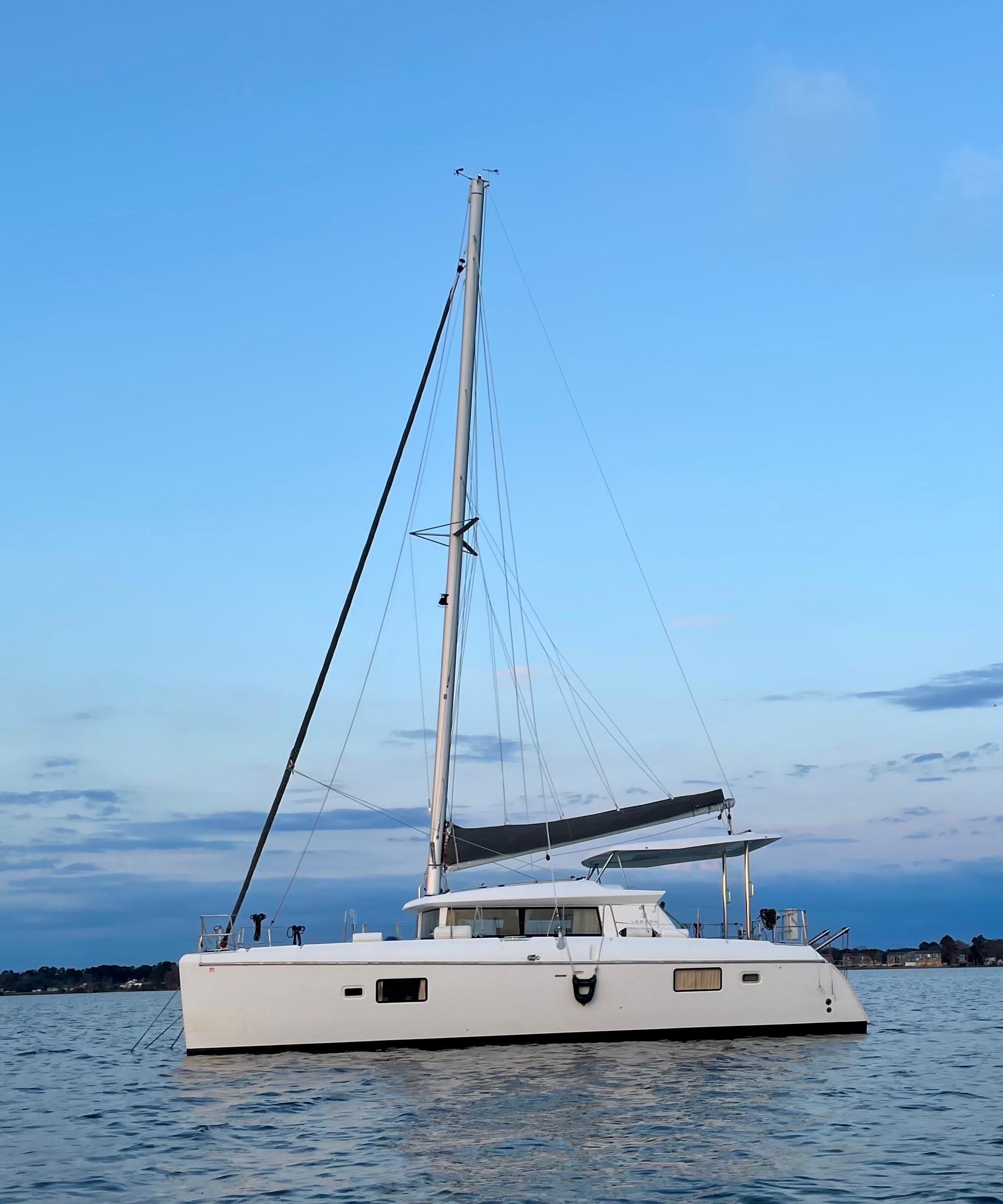 Lagoon 420 2007 Lagoon 420 catamaran sailing on calm waters at sunset.