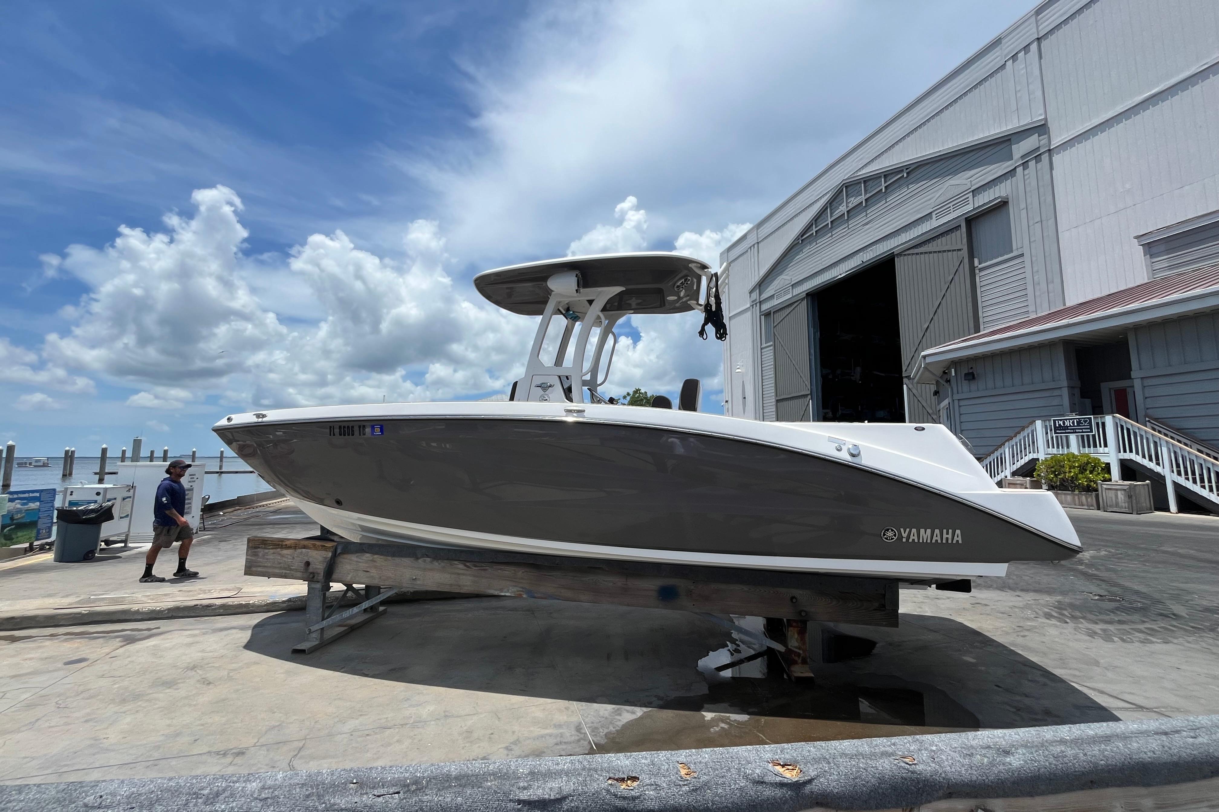 Yamaha Boats 252 FSH Sport 2022 Yamaha Boats 252 FSH Sport on dock, with cloudy sky background.