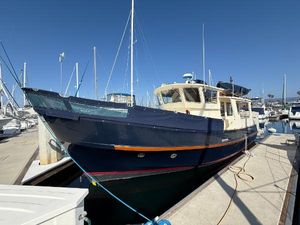 Fisher 38 Trawler 1978 Fisher 38 Trawler docked at marina under clear blue sky.