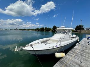 Contender 31 Fisharound 2004 Contender 31 Fish Around boat docked on a sunny day with blue skies.