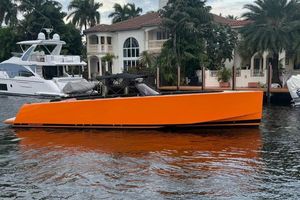 VanDutch 40 Open Bow Orange 2013 VanDutch 40 Open Bow yacht docked near luxury waterfront homes.