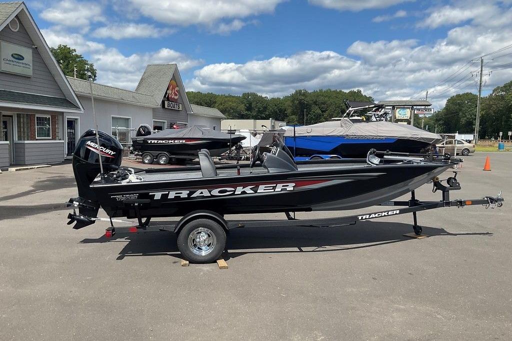 Tracker Pro Team 175 2025 Tracker Pro Team 175 boat displayed at dealership under blue sky.