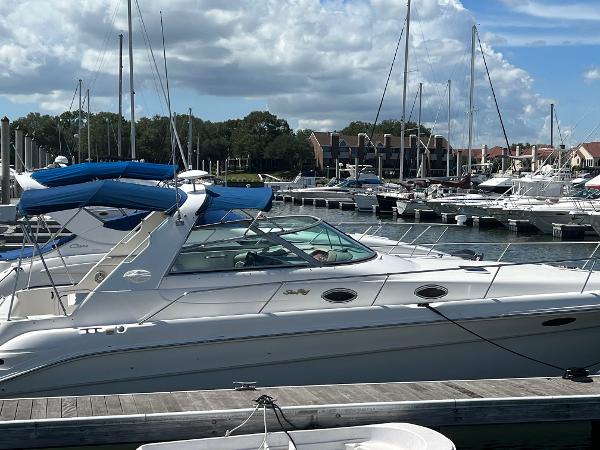 Sea Ray 330 Sundancer 1998 Sea Ray 330 Sundancer yacht docked at marina under cloudy sky.