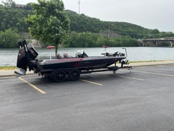 iKon LX 21 2024 iKon LX 21 boat on trailer by a scenic riverside parking lot.