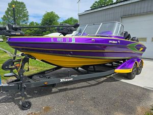 Triton Allure 206 2021 Triton Allure 206 boat in vibrant purple and yellow on a trailer.
