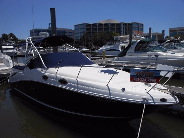 Sea Ray 270 Amberjack 2006 Sea Ray 270 Amberjack boat docked in marina, surrounded by other vessels.