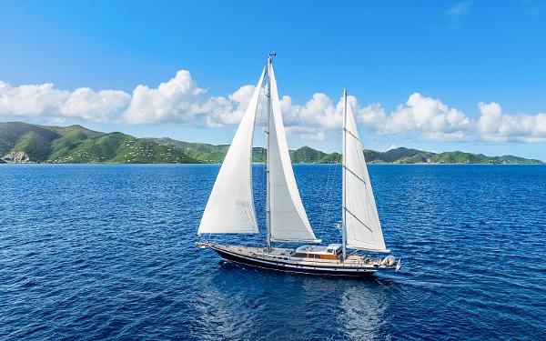 Jongert Ketch Sailing yacht Jongert Ketch 2002 on blue ocean with scenic island backdrop.